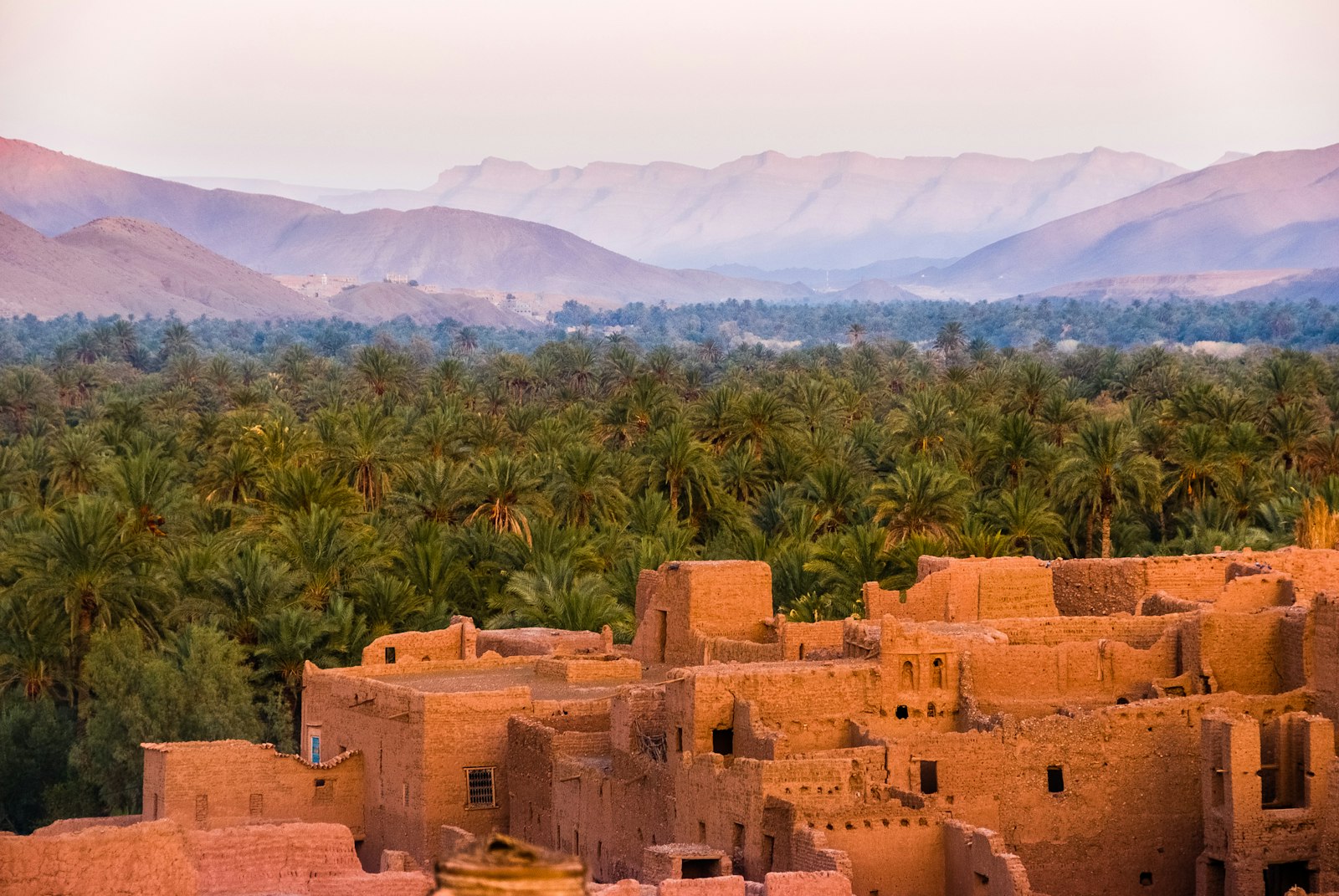 Earthen kasbah and palm oasis in southern Morocco